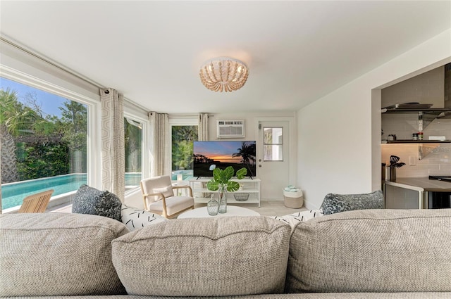 living room with a notable chandelier and a wall mounted AC
