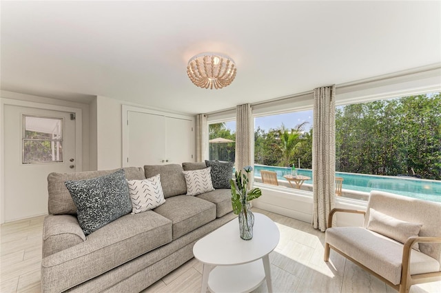 living area featuring a chandelier and light wood-style flooring