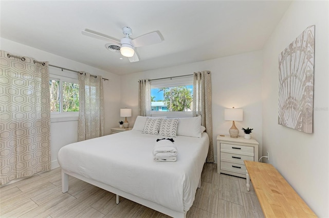 bedroom featuring visible vents, a ceiling fan, and wood tiled floor