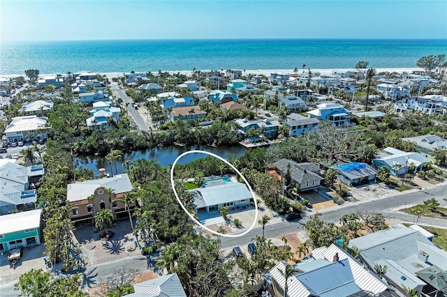 drone / aerial view featuring a residential view and a water view