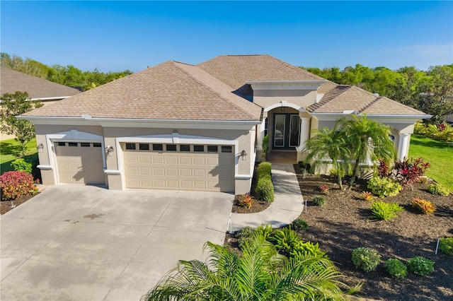 view of front of property with a shingled roof, concrete driveway, a garage, and stucco siding
