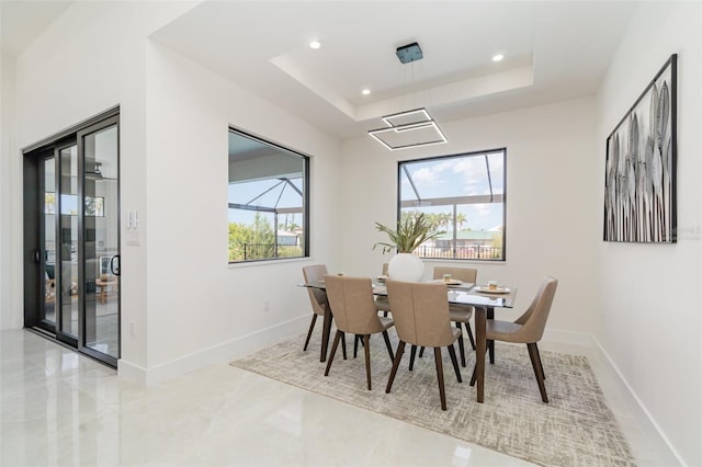 1815 SW 15th Pl, Cape Coral, FL 33991 - dining area featuring a tray ceiling, recessed lighting, and baseboards