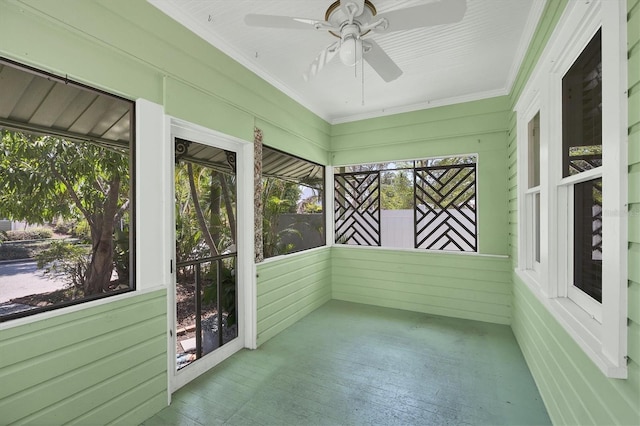 unfurnished sunroom with ceiling fan