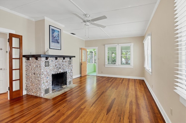 unfurnished living room with baseboards, a tiled fireplace, ceiling fan, crown molding, and hardwood / wood-style floors