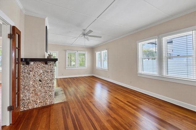 unfurnished living room featuring ornamental molding, wood-type flooring, ceiling fan, and baseboards