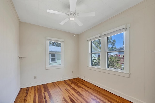 spare room with baseboards, a ceiling fan, and hardwood / wood-style floors