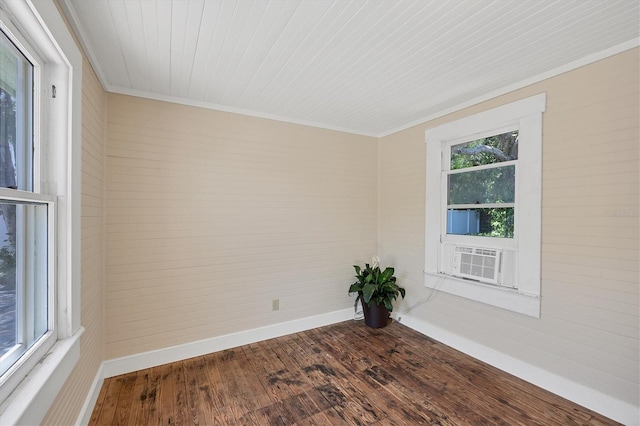 unfurnished room featuring baseboards, dark wood-style floors, cooling unit, crown molding, and wood ceiling