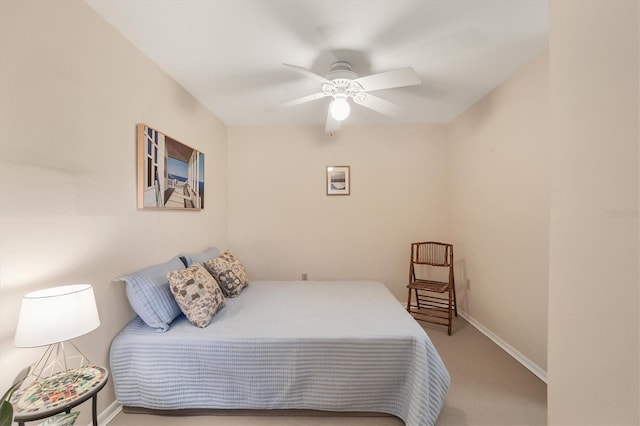 carpeted bedroom with baseboards and ceiling fan
