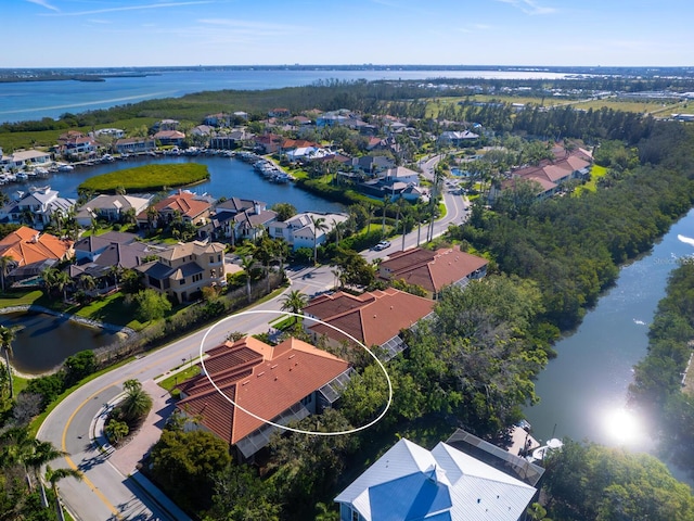 drone / aerial view with a residential view and a water view