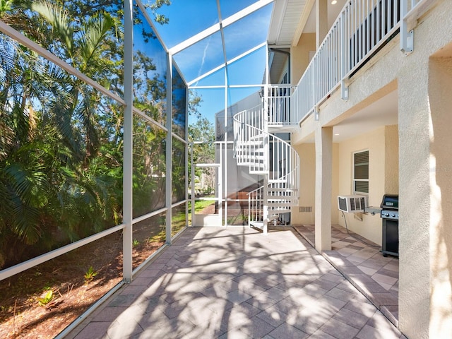 exterior space with a grill, stairs, a lanai, and cooling unit