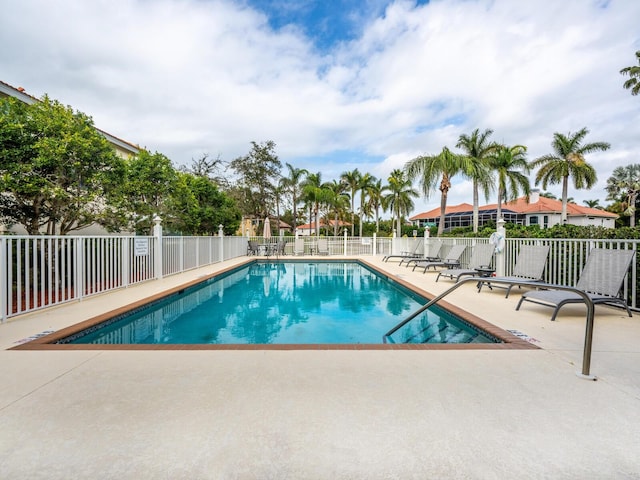 pool with fence and a patio area