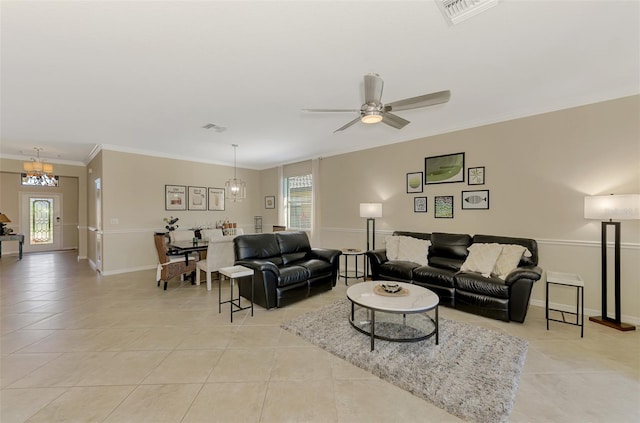 living area featuring light tile patterned flooring, ornamental molding, a healthy amount of sunlight, and visible vents