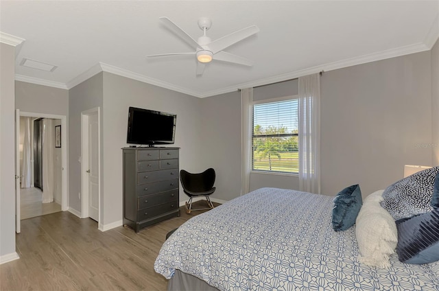 bedroom with baseboards, ornamental molding, wood finished floors, and ceiling fan