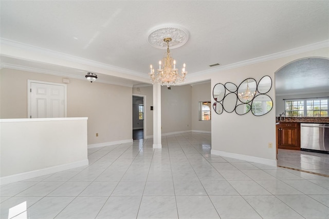 unfurnished room with visible vents, ornamental molding, an inviting chandelier, light tile patterned floors, and baseboards
