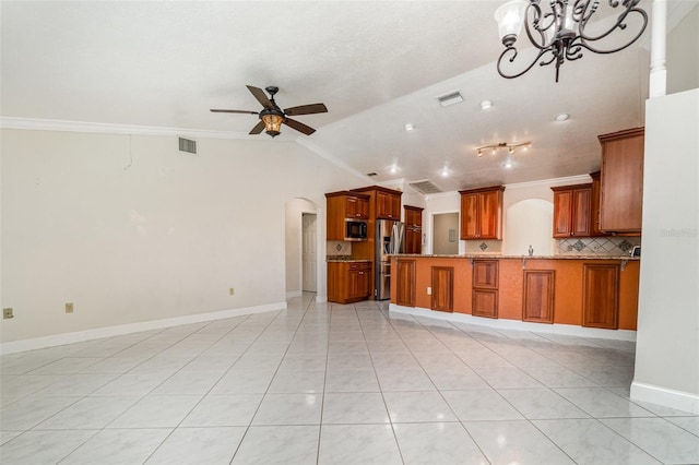 kitchen with brown cabinets, appliances with stainless steel finishes, crown molding, ceiling fan with notable chandelier, and open floor plan