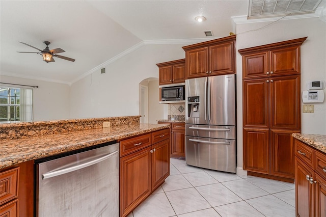 kitchen with light stone counters, ceiling fan, vaulted ceiling, appliances with stainless steel finishes, and crown molding