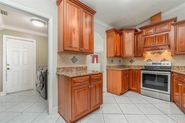 kitchen featuring light stone counters, separate washer and dryer, crown molding, light tile patterned floors, and stainless steel electric range oven