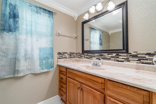 bathroom with tasteful backsplash, vanity, a textured wall, and ornamental molding