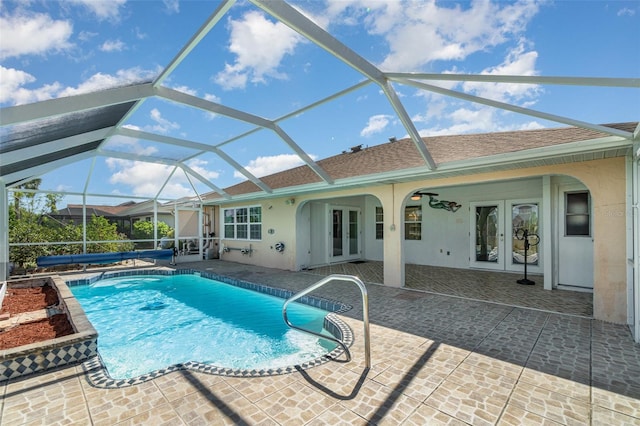 view of pool with a covered pool, a patio area, french doors, and a lanai