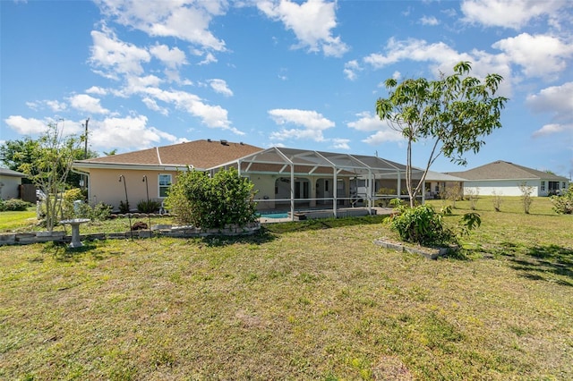 back of property featuring a swimming pool, glass enclosure, a yard, and stucco siding