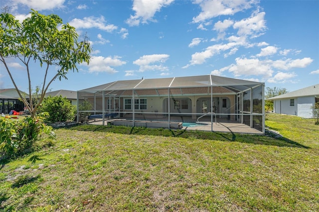 back of house with a lanai, a lawn, an outdoor pool, and a patio