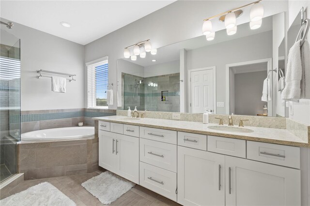 5954 Anise Dr, Sarasota, FL 34238 - full bath featuring a stall shower, double vanity, tile patterned flooring, and a garden tub