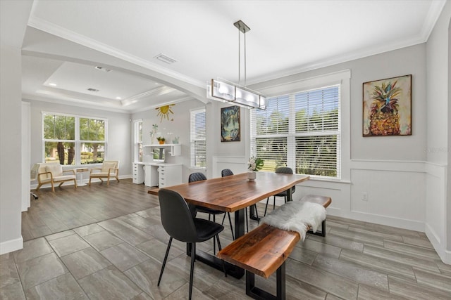 5954 Anise Dr, Sarasota, FL 34238 - dining area with crown molding, light wood-type flooring, arched walkways, and a wainscoted wall
