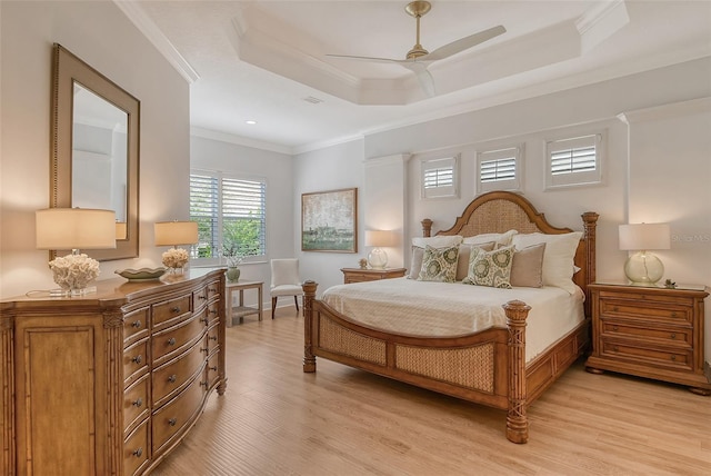 7137 Orchid Island Pl, Bradenton, FL 34202 - bedroom with crown molding, a tray ceiling, ceiling fan, and light wood-style floors