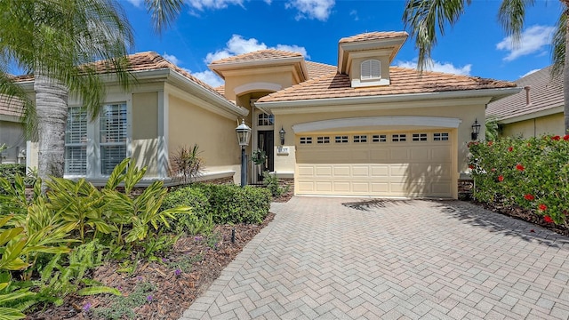 7137 Orchid Island Pl, Bradenton, FL 34202 - mediterranean / spanish-style home featuring a garage, stucco siding, decorative driveway, and a tile roof