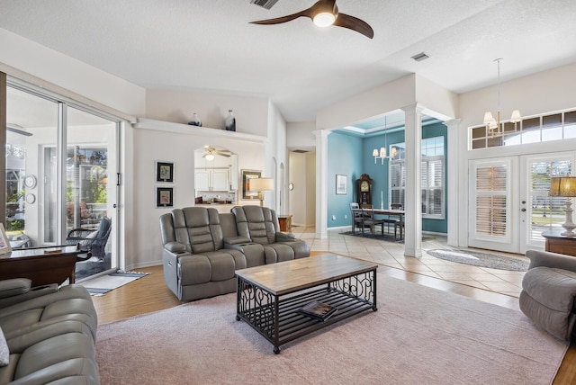 2439 Sonoma Dr W, Nokomis, FL 34275 - living area featuring decorative columns, ceiling fan, a chandelier, healthy amount of natural light, and a textured ceiling