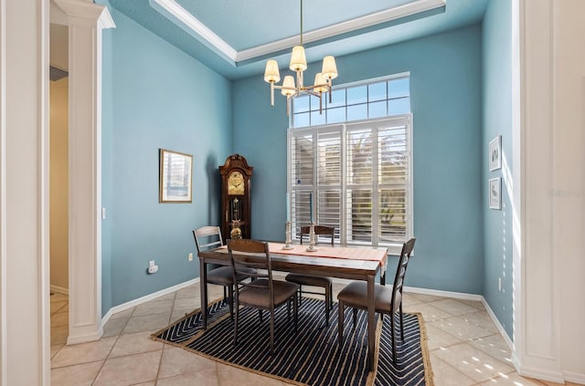 2439 Sonoma Dr W, Nokomis, FL 34275 - dining room with light tile patterned flooring, a chandelier, baseboards, and a tray ceiling