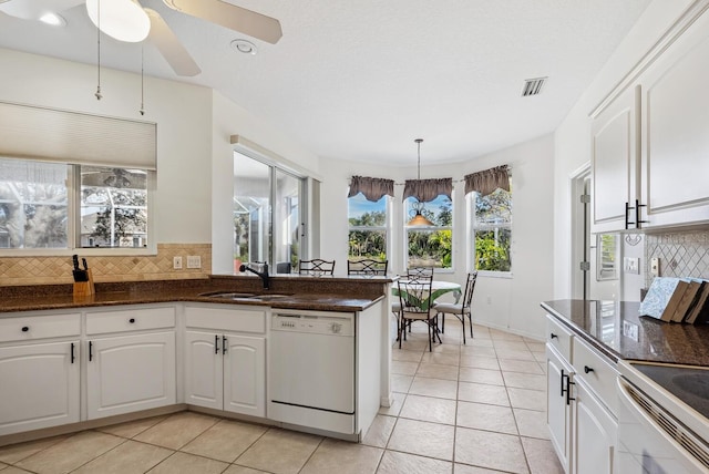 2439 Sonoma Dr W, Nokomis, FL 34275 - kitchen with white appliances, a sink, tasteful backsplash, white cabinets, and light tile patterned floors