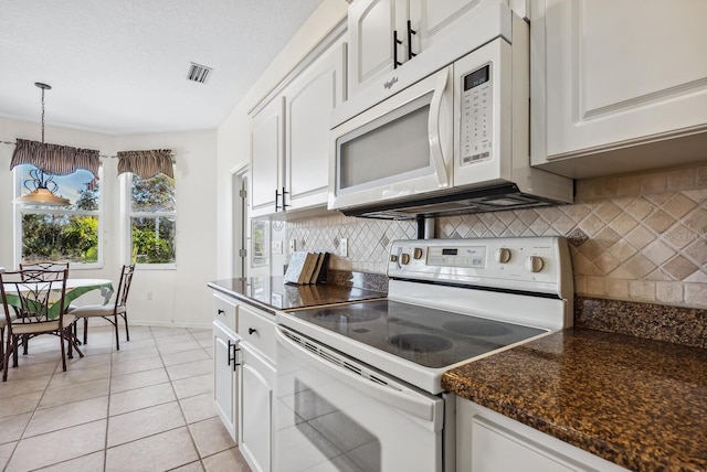 2439 Sonoma Dr W, Nokomis, FL 34275 - kitchen with white appliances, white cabinets, backsplash, light tile patterned floors, and pendant lighting