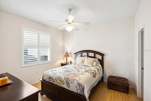 2439 Sonoma Dr W, Nokomis, FL 34275 - bedroom with light wood-style flooring, baseboards, and a ceiling fan