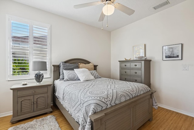 2439 Sonoma Dr W, Nokomis, FL 34275 - bedroom with light wood-type flooring, baseboards, and a ceiling fan