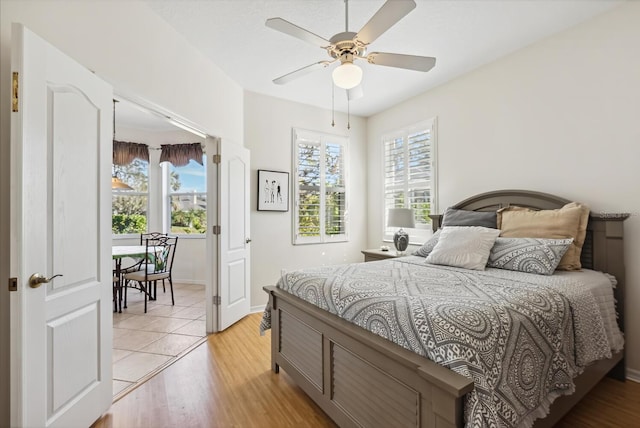 2439 Sonoma Dr W, Nokomis, FL 34275 - bedroom featuring multiple windows, light wood finished floors, and ceiling fan