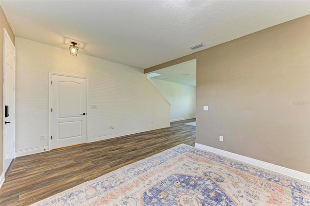 10614 Morning Marsh Ln, Parrish, FL 34219 - spare room with wood finished floors, baseboards, and a textured ceiling