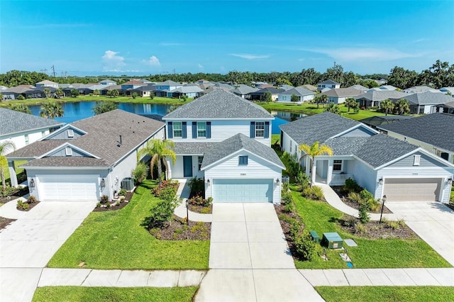 10614 Morning Marsh Ln, Parrish, FL 34219 - traditional-style home with a residential view, driveway, a front lawn, a water view, and a garage