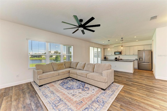 10614 Morning Marsh Ln, Parrish, FL 34219 - living area with a ceiling fan, light wood-style floors, recessed lighting, and a textured ceiling