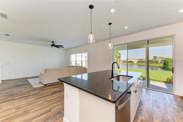 10614 Morning Marsh Ln, Parrish, FL 34219 - kitchen with dishwasher, light wood-type flooring, white cabinetry, pendant lighting, and recessed lighting