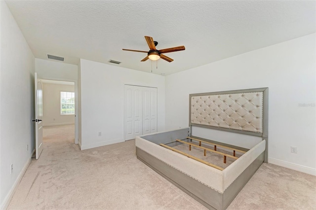 10614 Morning Marsh Ln, Parrish, FL 34219 - unfurnished bedroom with carpet floors, a closet, and a ceiling fan