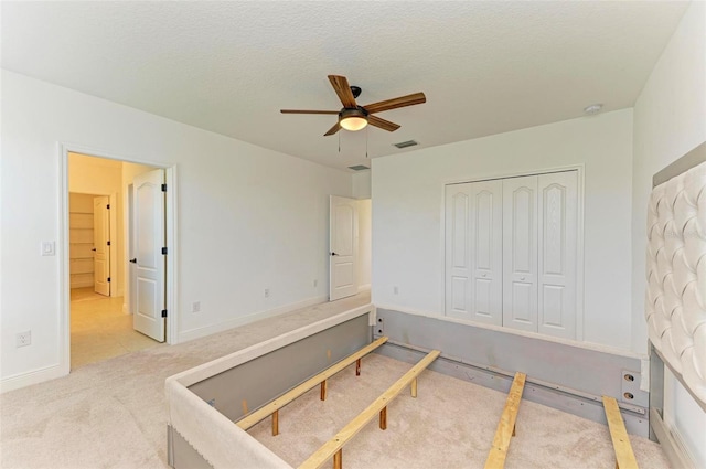 10614 Morning Marsh Ln, Parrish, FL 34219 - unfurnished bedroom with carpet floors, a closet, and a ceiling fan