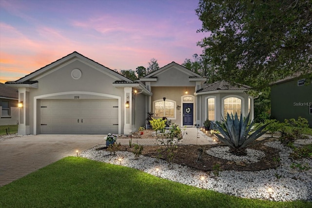 259 Golden Harbour Trl, Bradenton, FL 34212 - ranch-style house featuring decorative driveway, a garage, and stucco siding
