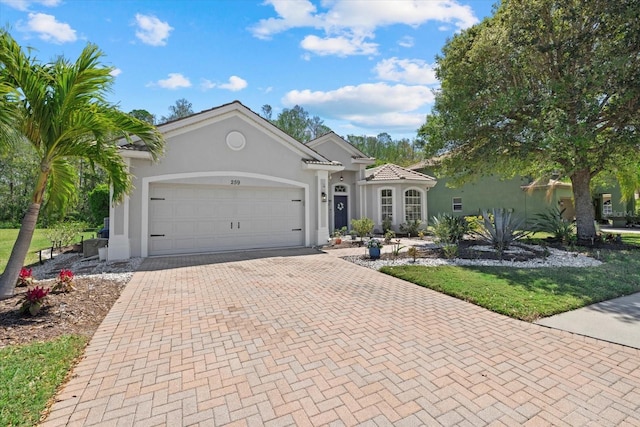 259 Golden Harbour Trl, Bradenton, FL 34212 - view of front of property featuring decorative driveway, an attached garage, and stucco siding