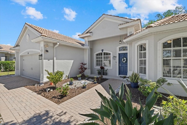 259 Golden Harbour Trl, Bradenton, FL 34212 - view of front facade with stucco siding, a tiled roof, decorative driveway, and a garage