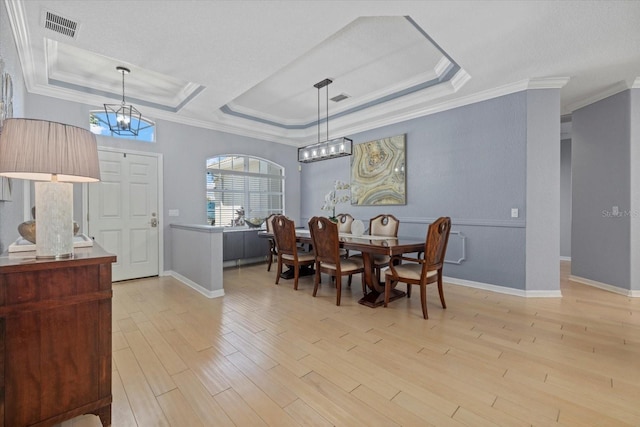 259 Golden Harbour Trl, Bradenton, FL 34212 - dining room featuring visible vents, a notable chandelier, ornamental molding, wood finished floors, and a raised ceiling