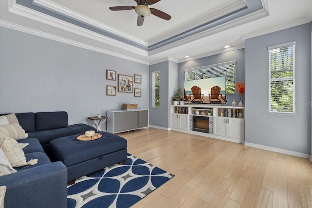 259 Golden Harbour Trl, Bradenton, FL 34212 - living area with light wood finished floors, baseboards, a raised ceiling, and ceiling fan