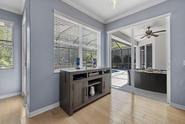 259 Golden Harbour Trl, Bradenton, FL 34212 - kitchen featuring light wood-style flooring, crown molding, a healthy amount of sunlight, and ceiling fan
