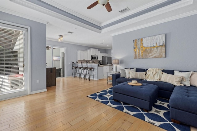 259 Golden Harbour Trl, Bradenton, FL 34212 - living area featuring plenty of natural light, a raised ceiling, light wood-style floors, and a ceiling fan