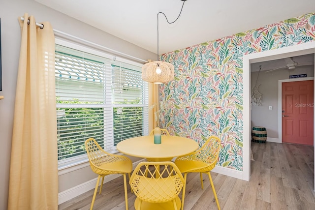 dining space featuring baseboards and wood finished floors
